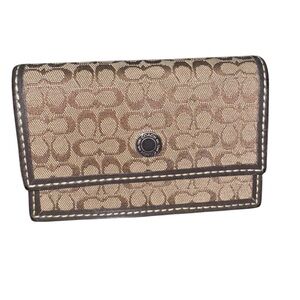 Coach brown signature jacquard snap card wallet.
